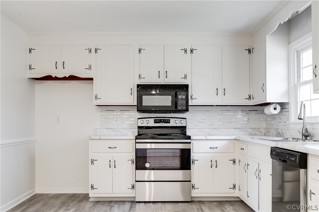 13007 Buckland Road Chester, VA 23831 - Photo 15 of 44 a kitchen with granite countertop white cabinets and appliances