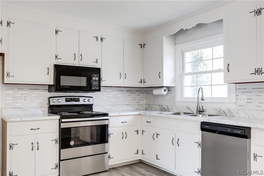 13007 Buckland Road Chester, VA 23831 - Photo 17 of 44 a kitchen with white cabinets appliances and a sink
