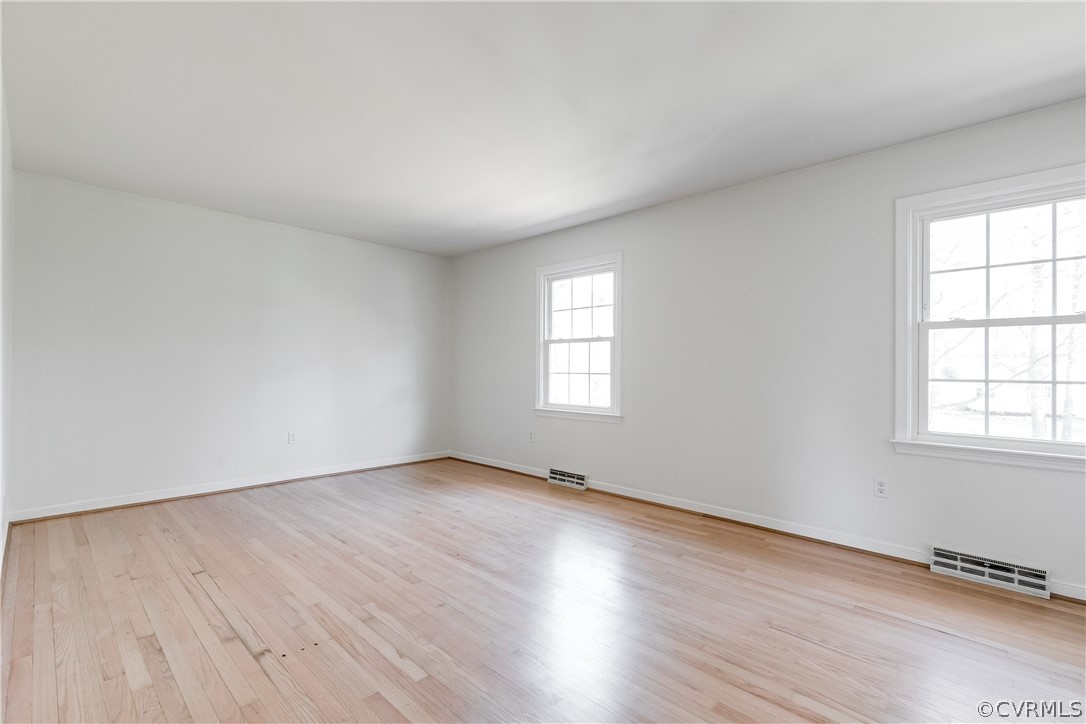 13007 Buckland Road Chester, VA 23831 - Photo 23 of 44 an empty room with wooden floor and windows