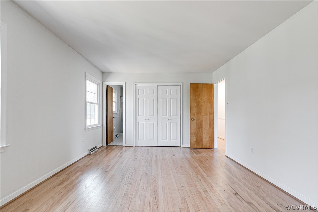 13007 Buckland Road Chester, VA 23831 - Photo 24 of 44 an empty room with wooden floor and windows