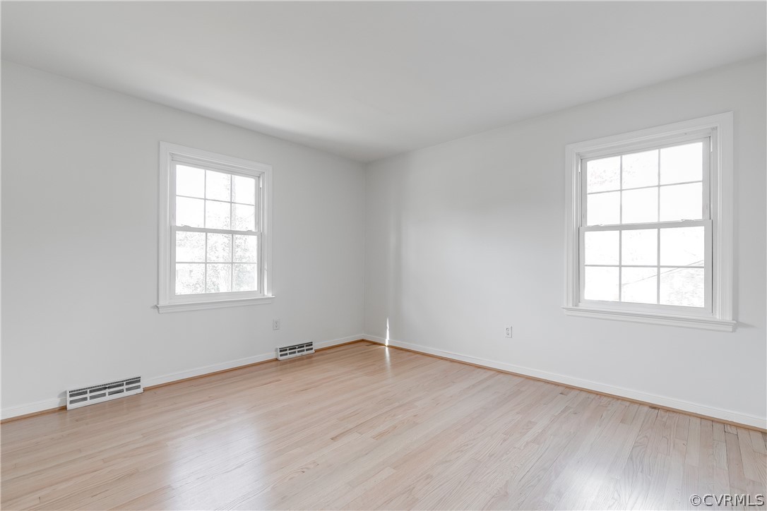 13007 Buckland Road Chester, VA 23831 - Photo 26 of 44 an empty room with wooden floor and windows