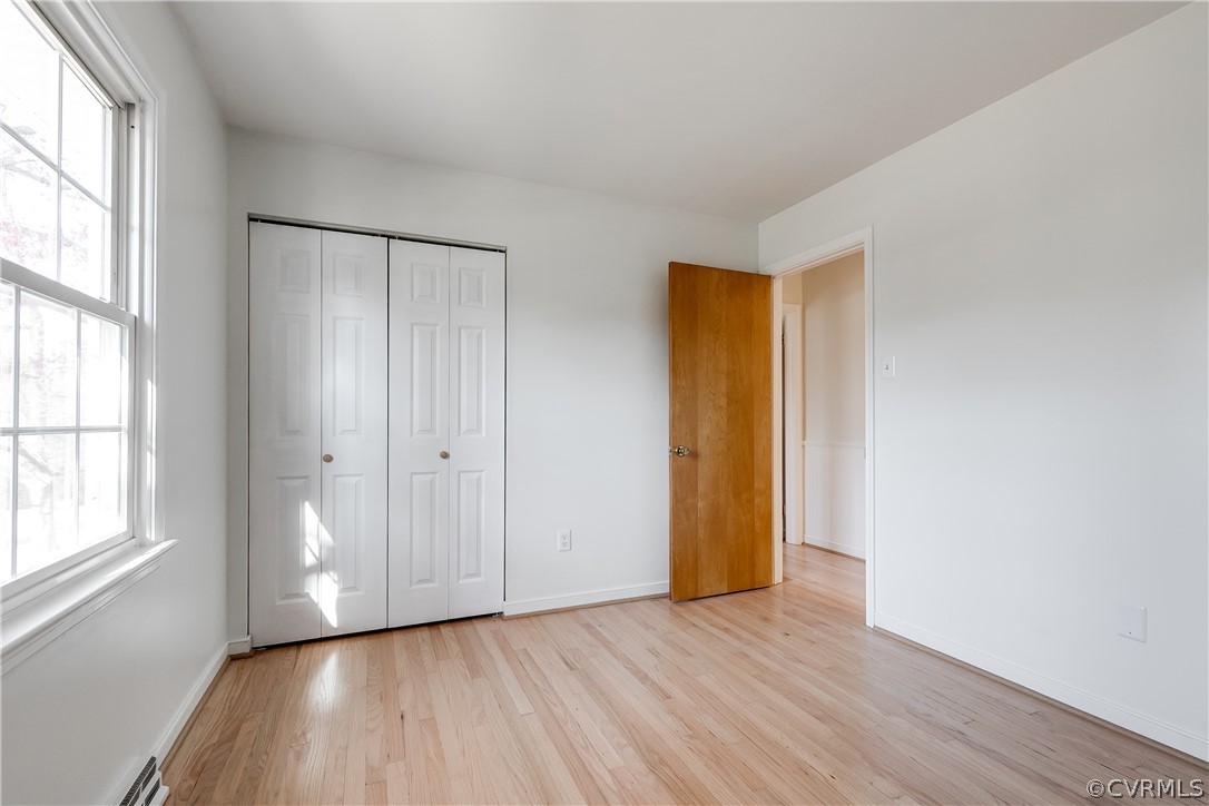 13007 Buckland Road Chester, VA 23831 - Photo 29 of 44 an empty room with wooden floor and windows