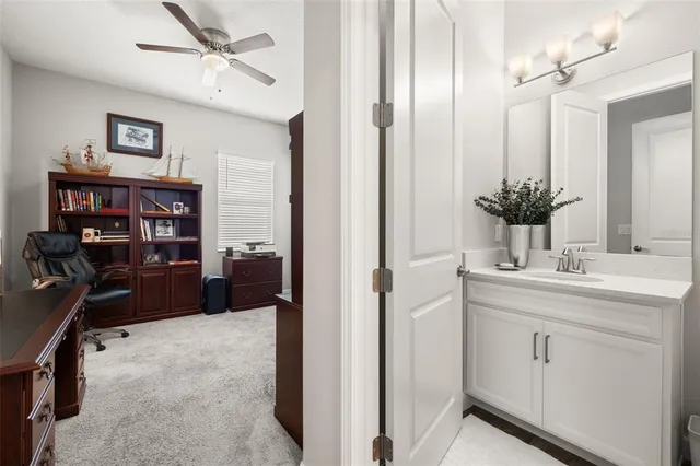 a view of a workspace with furniture and a window
