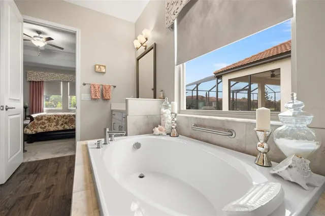 a kitchen with a sink a refrigerator and white cabinets