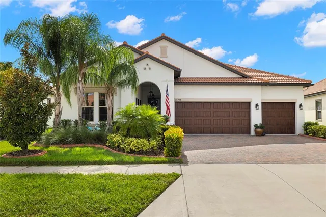 a front view of a house with a yard and garage