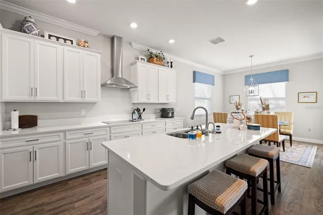 a view of a patio with table and chairs potted plants