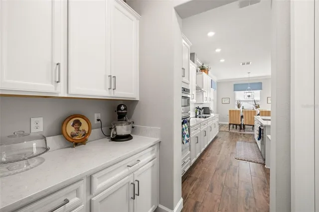 a view of a patio with a table and chairs under an umbrella