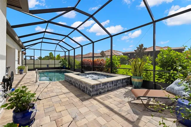 an aerial view of a swimming pool a yard and outdoor seating
