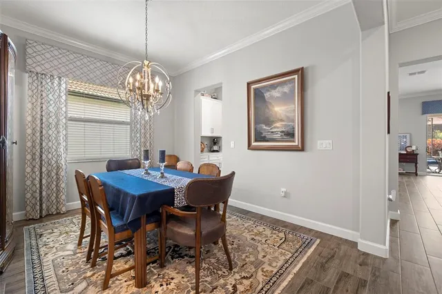 a view of a dining room with furniture and chandelier