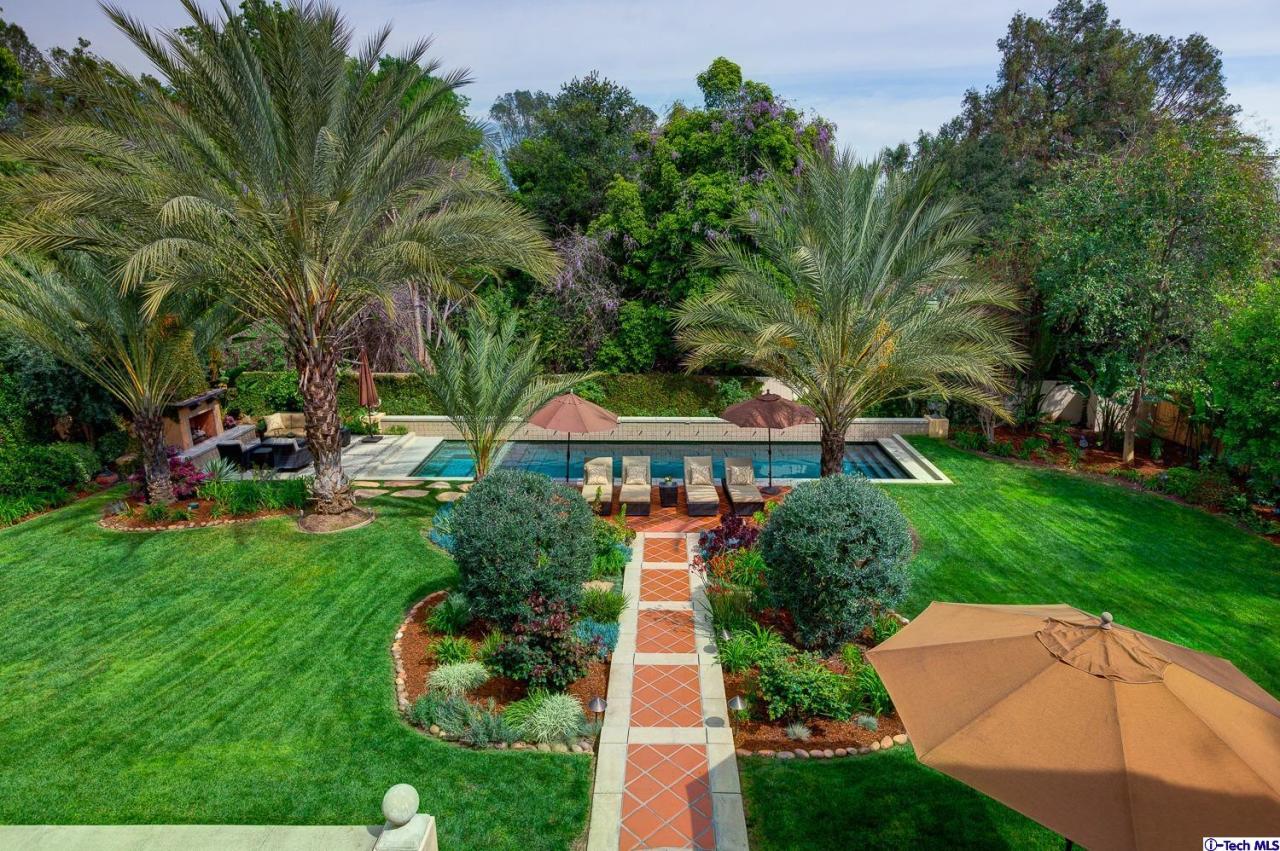 Undisclosed Address Pasadena, CA 91103 - Photo 44 of 80 a front view of a house with a yard and potted plants