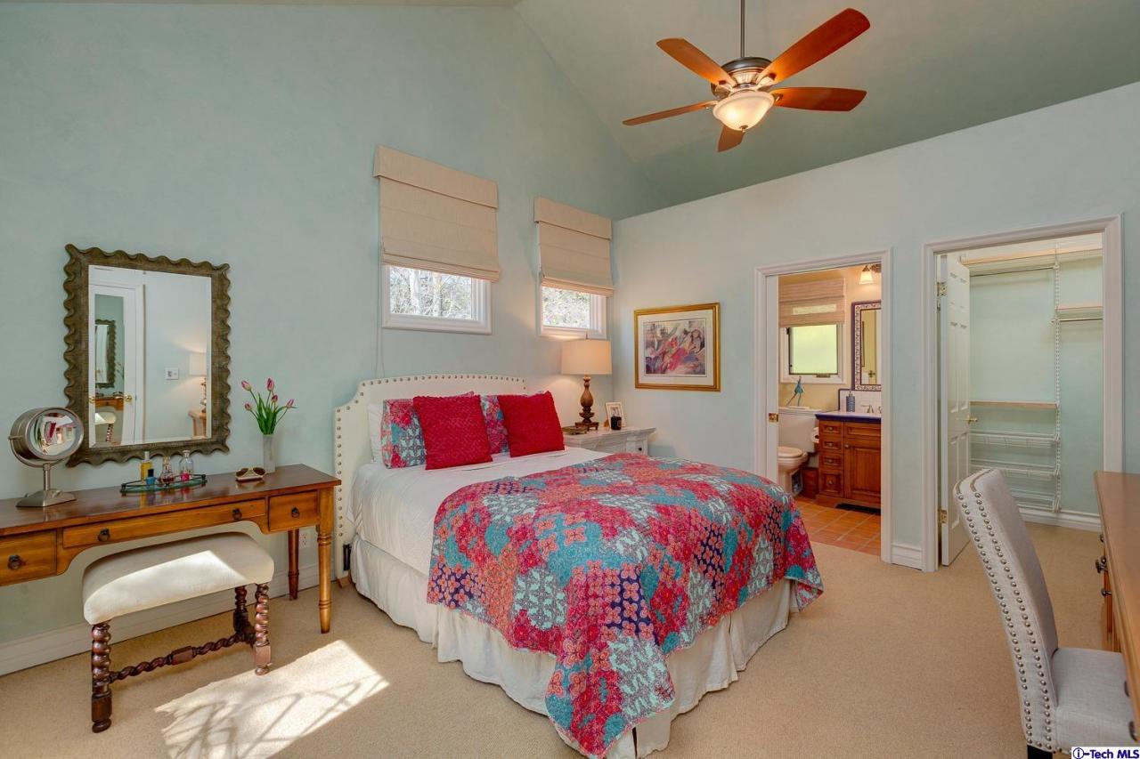 Undisclosed Address Pasadena, CA 91103 - Photo 55 of 80 a bedroom with a bed and a chandelier