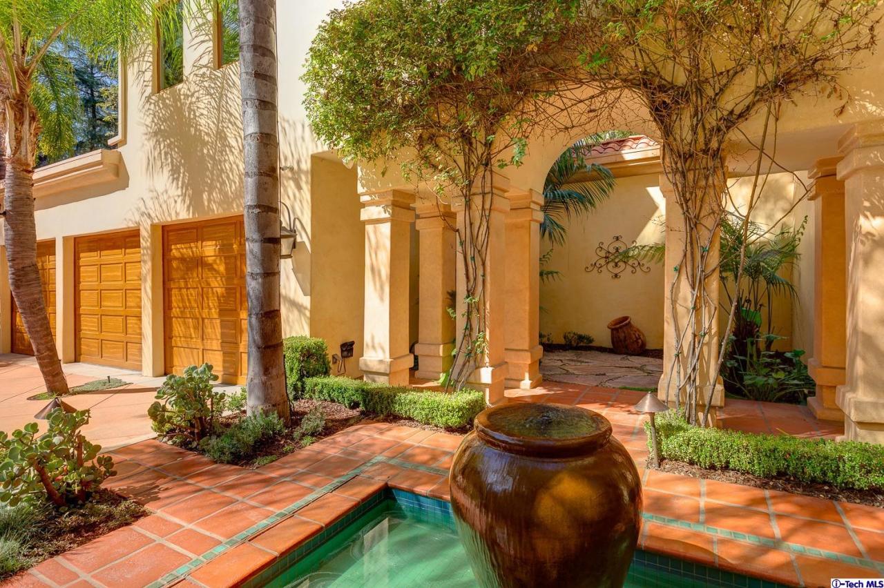 Undisclosed Address Pasadena, CA 91103 - Photo 8 of 80 a view of a patio with table and chairs potted plants and large tree