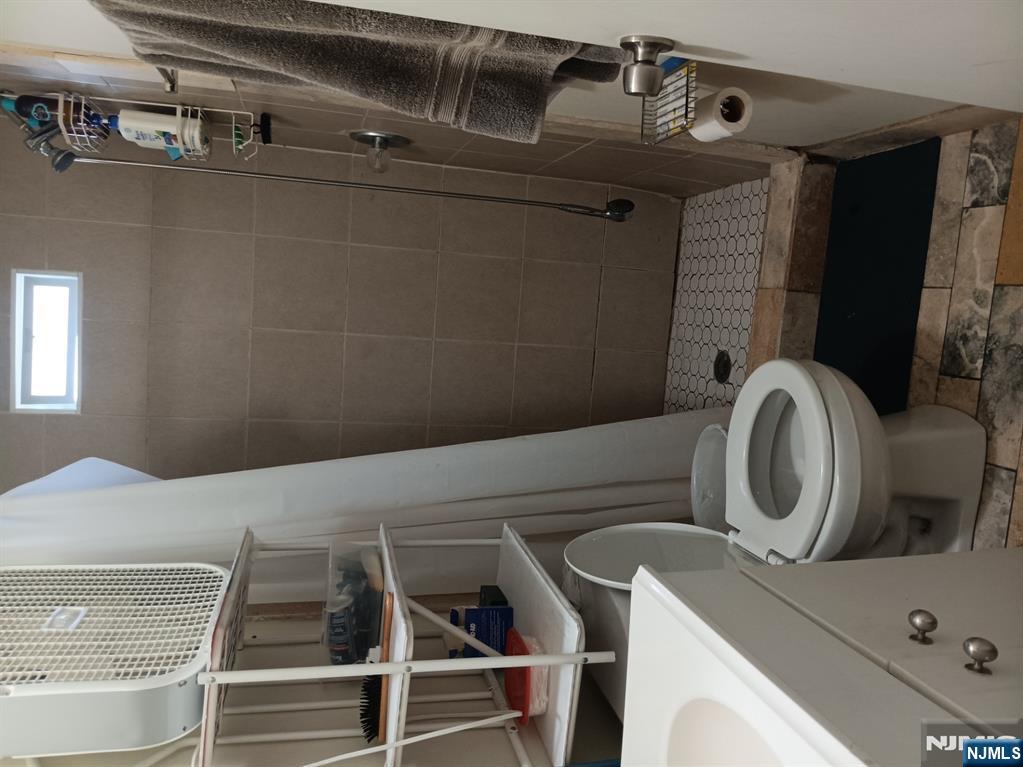 40 Poplar Street Lodi, NJ 07644 - Photo 11 of 16 a bathroom with a toilet and a sink