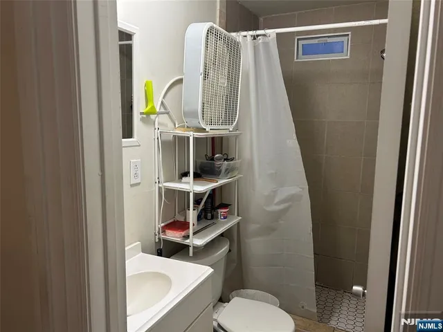 a bathroom with a toilet and a shower