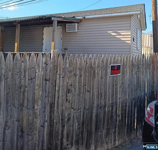 a front view of a house with a wooden fence