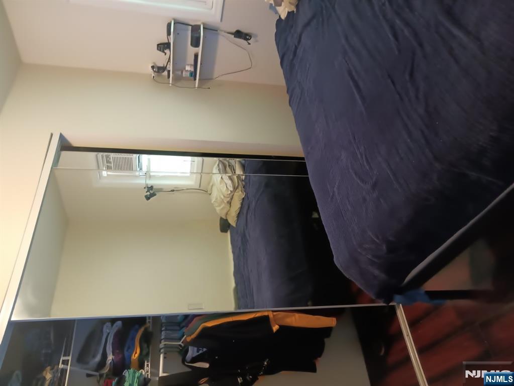 40 Poplar Street Lodi, NJ 07644 - Photo 10 of 16 a bedroom with a bed and wooden floor