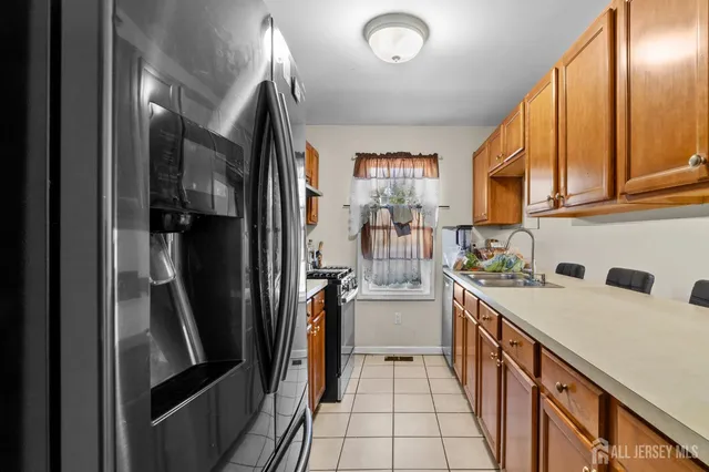 a kitchen that has a lot of cabinets and refrigerator