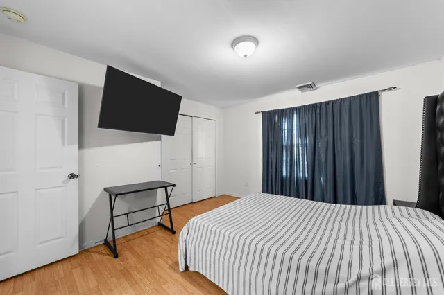 a bedroom with a bed and a flat screen tv