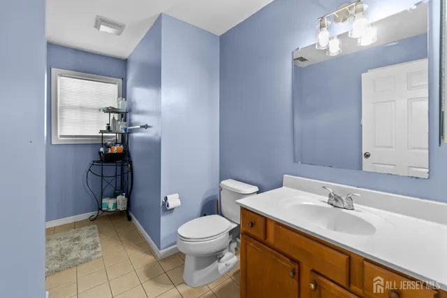 a bathroom with a sink a toilet and mirror