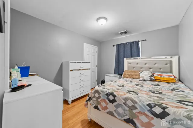 a bedroom with a bed and a lamp