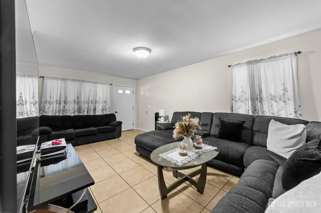 a living room with furniture a rug and a flat screen tv
