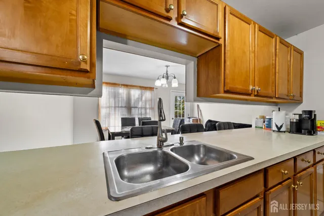 a kitchen with a sink cabinets and a window