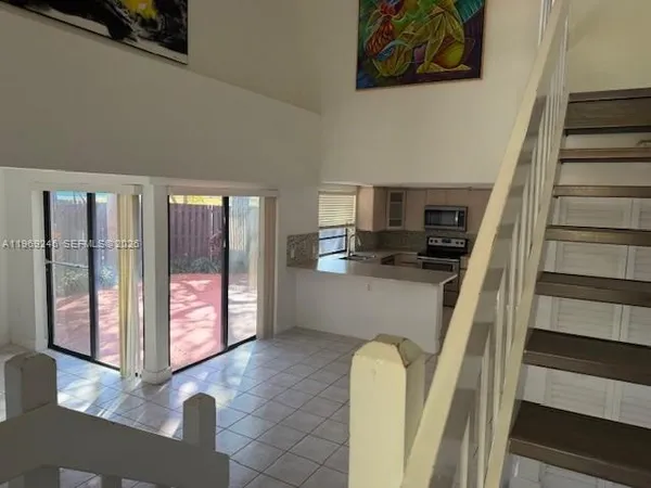 a kitchen with stainless steel appliances a refrigerator and a stove top oven