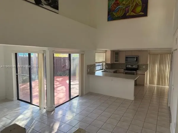 a kitchen with stainless steel appliances a refrigerator and microwave
