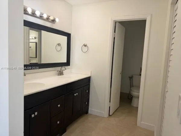 a bathroom with a double vanity sink and a mirror