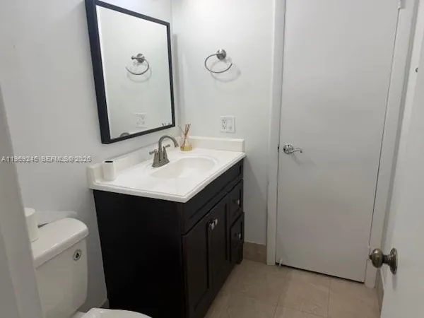 a bathroom with a sink vanity and a mirror