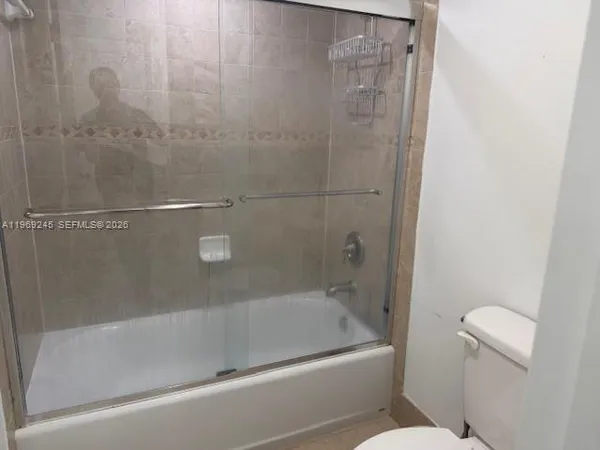 a bathroom with a shower and a toilet