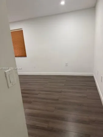 a view of an empty room and wooden floor