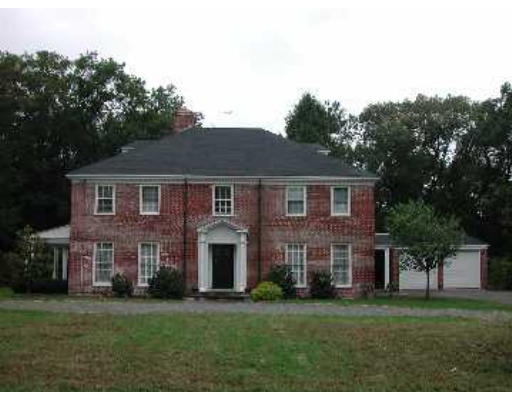 52 Clarke Circle Needham, MA 02492 - Photo 1 of 9 a front view of a house with a garden