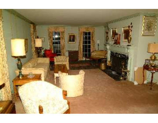 52 Clarke Circle Needham, MA 02492 - Photo 3 of 9 a living room with furniture and a fireplace