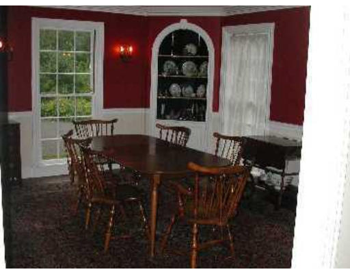 52 Clarke Circle Needham, MA 02492 - Photo 7 of 9 a view of a dining room with furniture and chandelier
