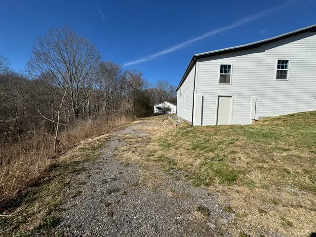 a backyard of a house with large trees