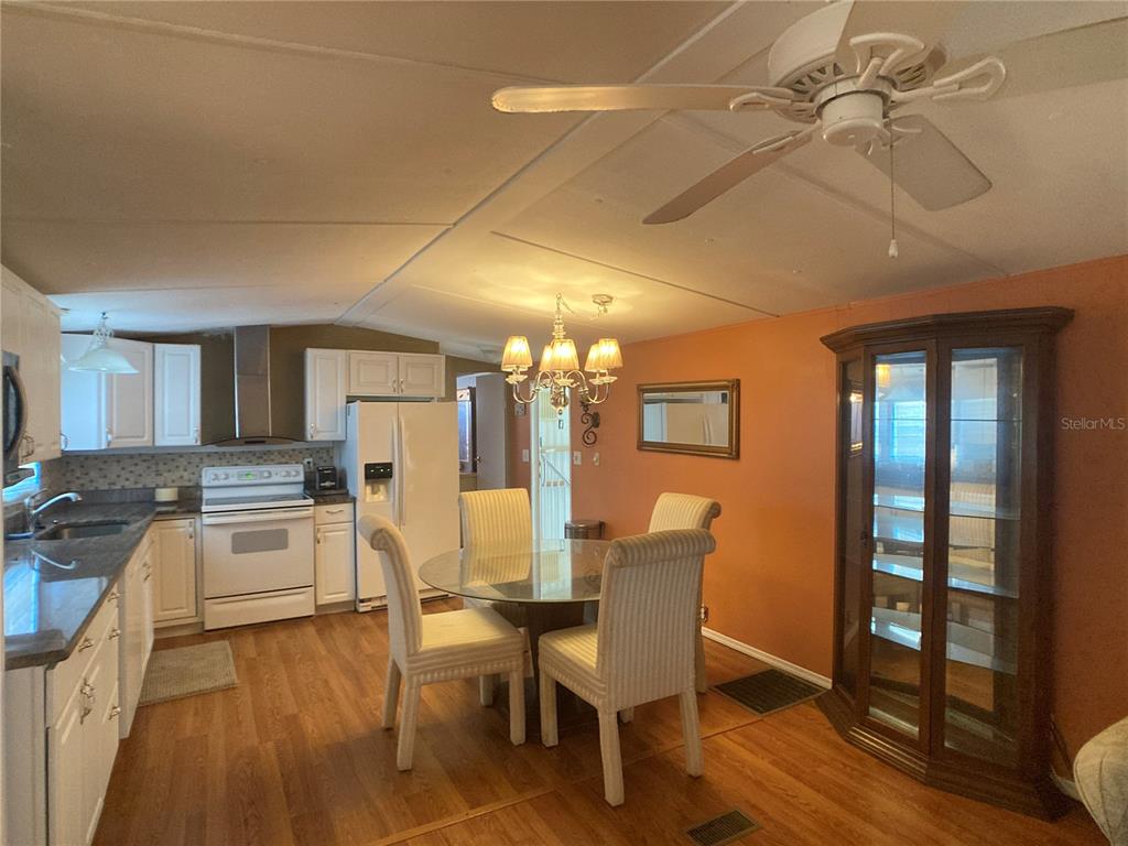 1710 7th Street Southwest, Unit 44 Ruskin, FL 33570 - Photo 14 of 34 a large kitchen with a table and chairs in it