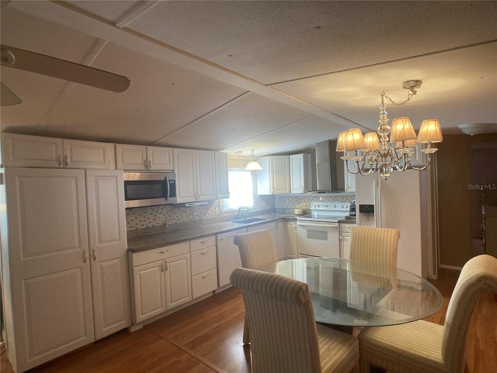1710 7th Street Southwest, Unit 44 Ruskin, FL 33570 - Photo 16 of 34 a kitchen with kitchen island white cabinets and stainless steel appliances