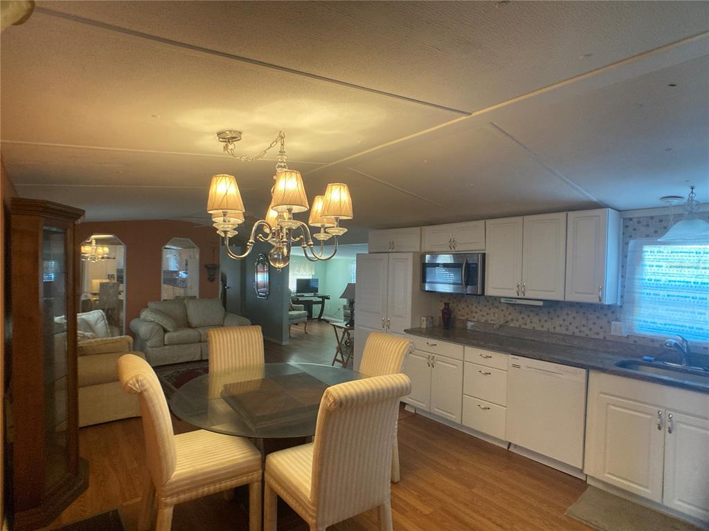 1710 7th Street Southwest, Unit 44 Ruskin, FL 33570 - Photo 17 of 34 a view of a dining room with furniture and wooden floor