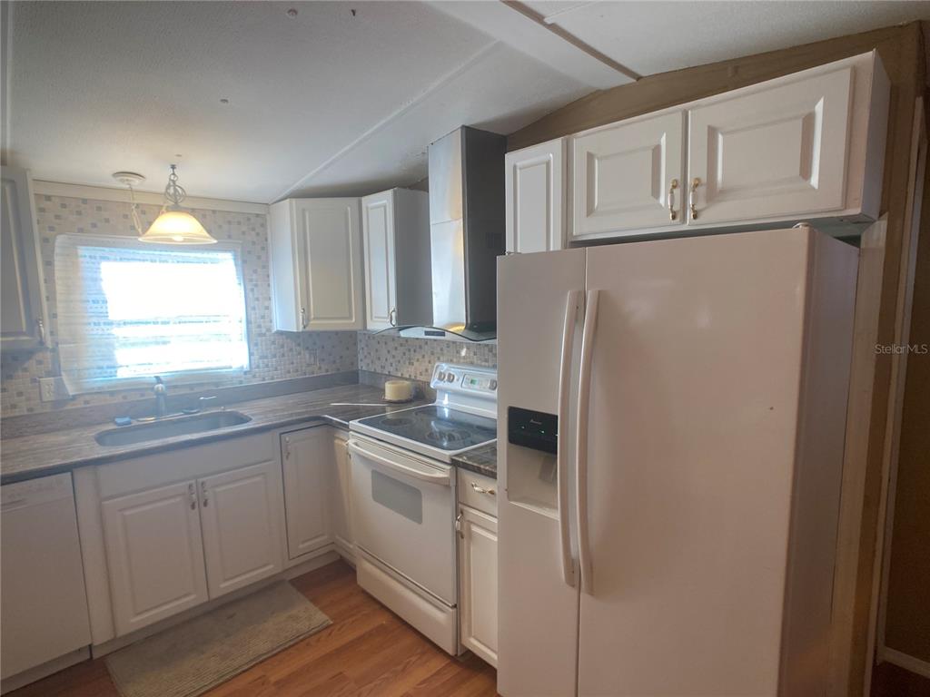 1710 7th Street Southwest, Unit 44 Ruskin, FL 33570 - Photo 19 of 34 a kitchen with white cabinets and white appliances