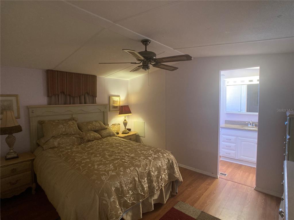 1710 7th Street Southwest, Unit 44 Ruskin, FL 33570 - Photo 20 of 34 a bedroom with a bed and a ceiling fan