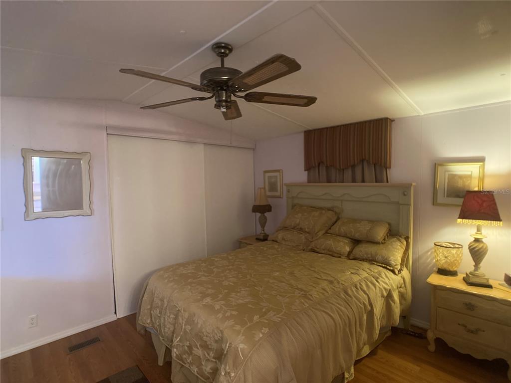 1710 7th Street Southwest, Unit 44 Ruskin, FL 33570 - Photo 21 of 34 a bedroom with a bed and ceiling fan