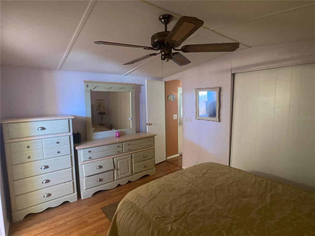 1710 7th Street Southwest, Unit 44 Ruskin, FL 33570 - Photo 22 of 34 a bedroom with a bed and a dresser