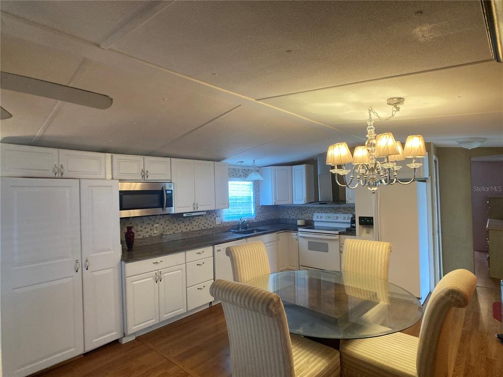 1710 7th Street Southwest, Unit 44 Ruskin, FL 33570 - Photo 23 of 34 a kitchen with kitchen island granite countertop a sink cabinets and stainless steel appliances