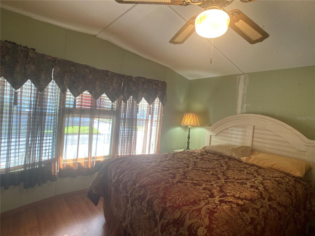 1710 7th Street Southwest, Unit 44 Ruskin, FL 33570 - Photo 26 of 34 a bedroom with a large bed and a large window