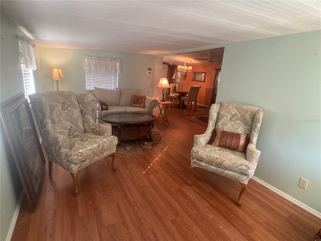1710 7th Street Southwest, Unit 44 Ruskin, FL 33570 - Photo 8 of 34 a living room with furniture and a wooden floor