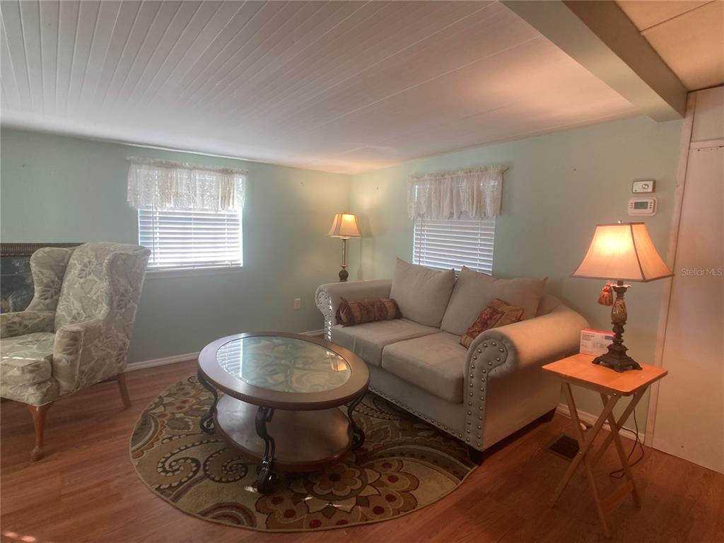 1710 7th Street Southwest, Unit 44 Ruskin, FL 33570 - Photo 9 of 34 a living room with furniture a lamp and a window