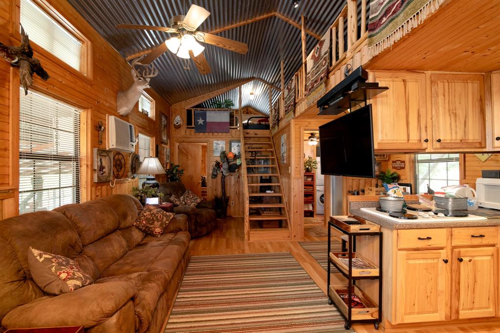 15055 County Road 306 Cisco, TX 76437 - Photo 12 of 40 a living room with furniture a chandelier and a dining table