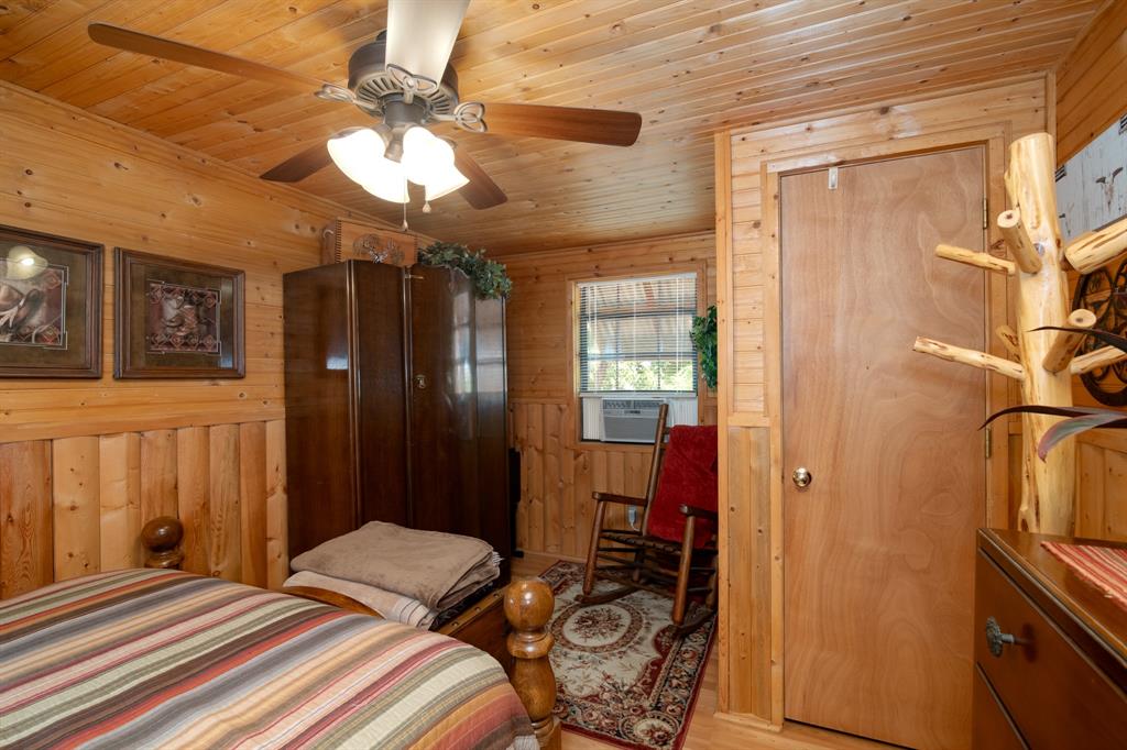 15055 County Road 306 Cisco, TX 76437 - Photo 15 of 40 a bedroom with a bed and a chandelier