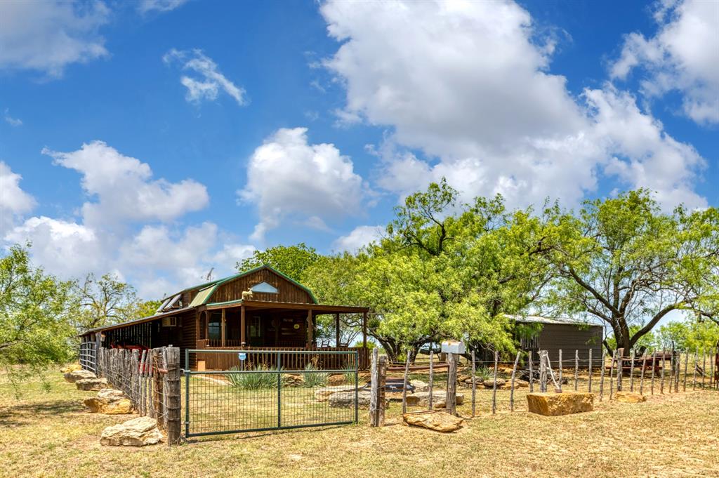15055 County Road 306 Cisco, TX 76437 - Photo 3 of 40 a front view of a house with garden
